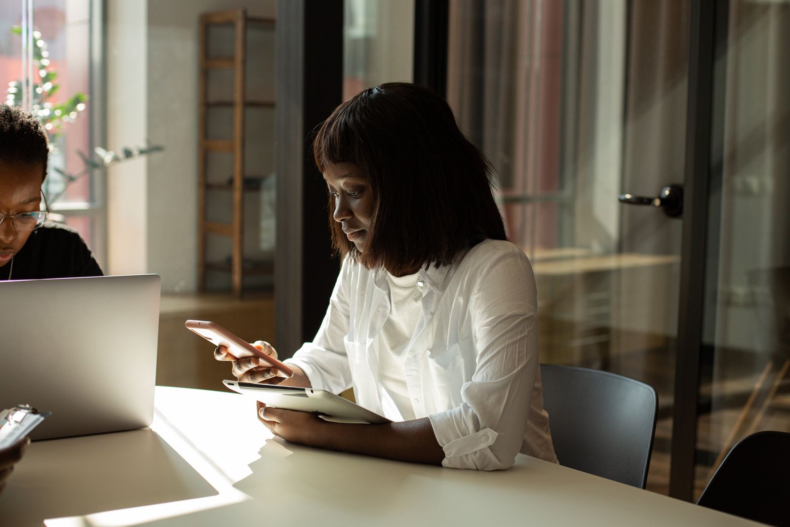 A crèche principal doing admin at her desk, phone in hand